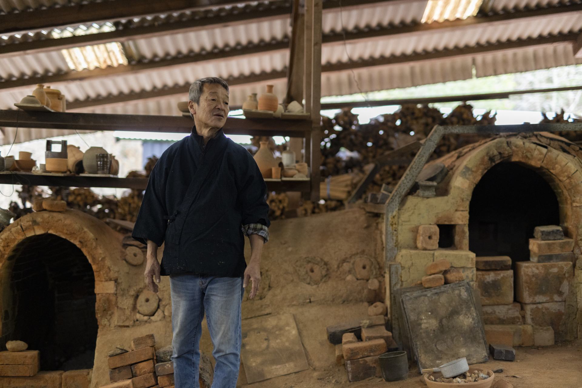 Potter Ichino Shinsui next to the kilns he built with his own two hands.