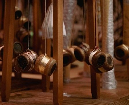 Balls of thread hanging from the loom